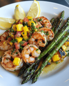 Shrimp with mango salsa, asparagus, and lemon wedges