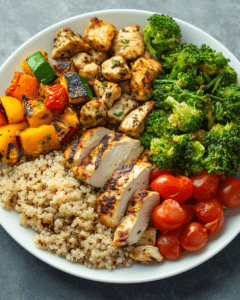 A plate divided into sections with quinoa, brown rice, and vegetables.