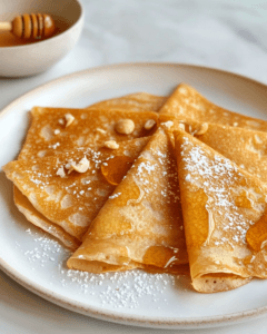 Thin pancakes made with water, served with honey