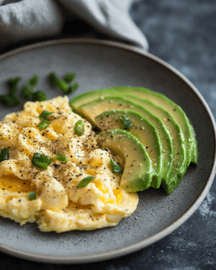 Scrambled eggs and avocado slices for a lazy keto meal