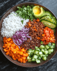 A plate split between rice and quinoa with fresh vegetables around it.