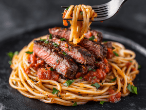 Spaghetti with grilled steak and spicy arrabbiata sauce